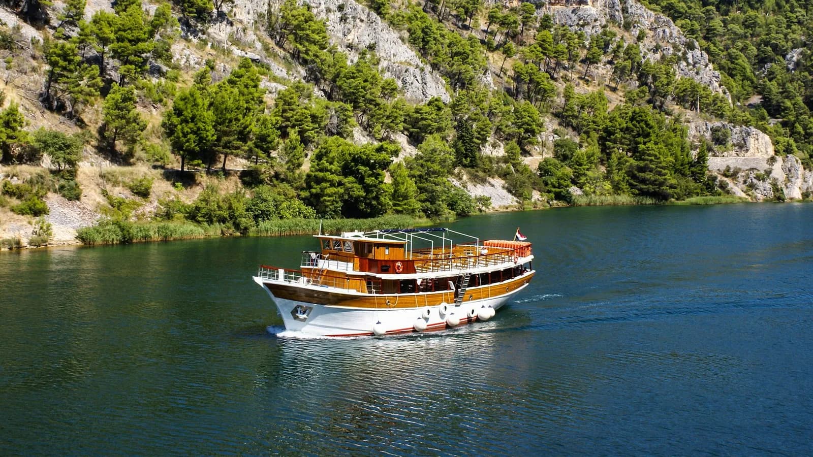 Boat excursion scene from the Sibenik archipelago for a Zlarin or Krapanj planning guide