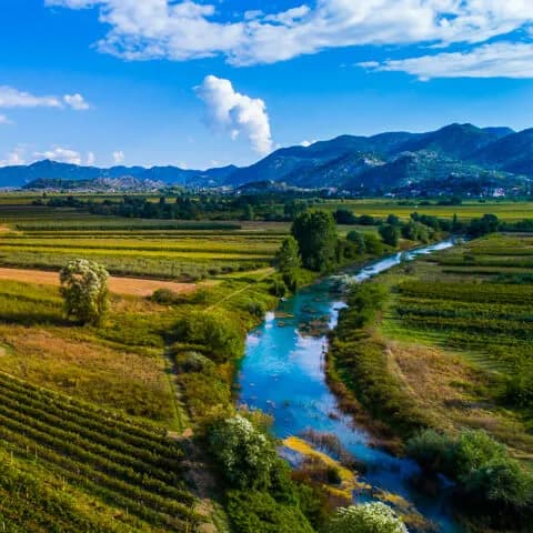 Official Ploce tourism aerial image of the Neretva valley landscape near the Ploce approach for a same day A1 driver alert