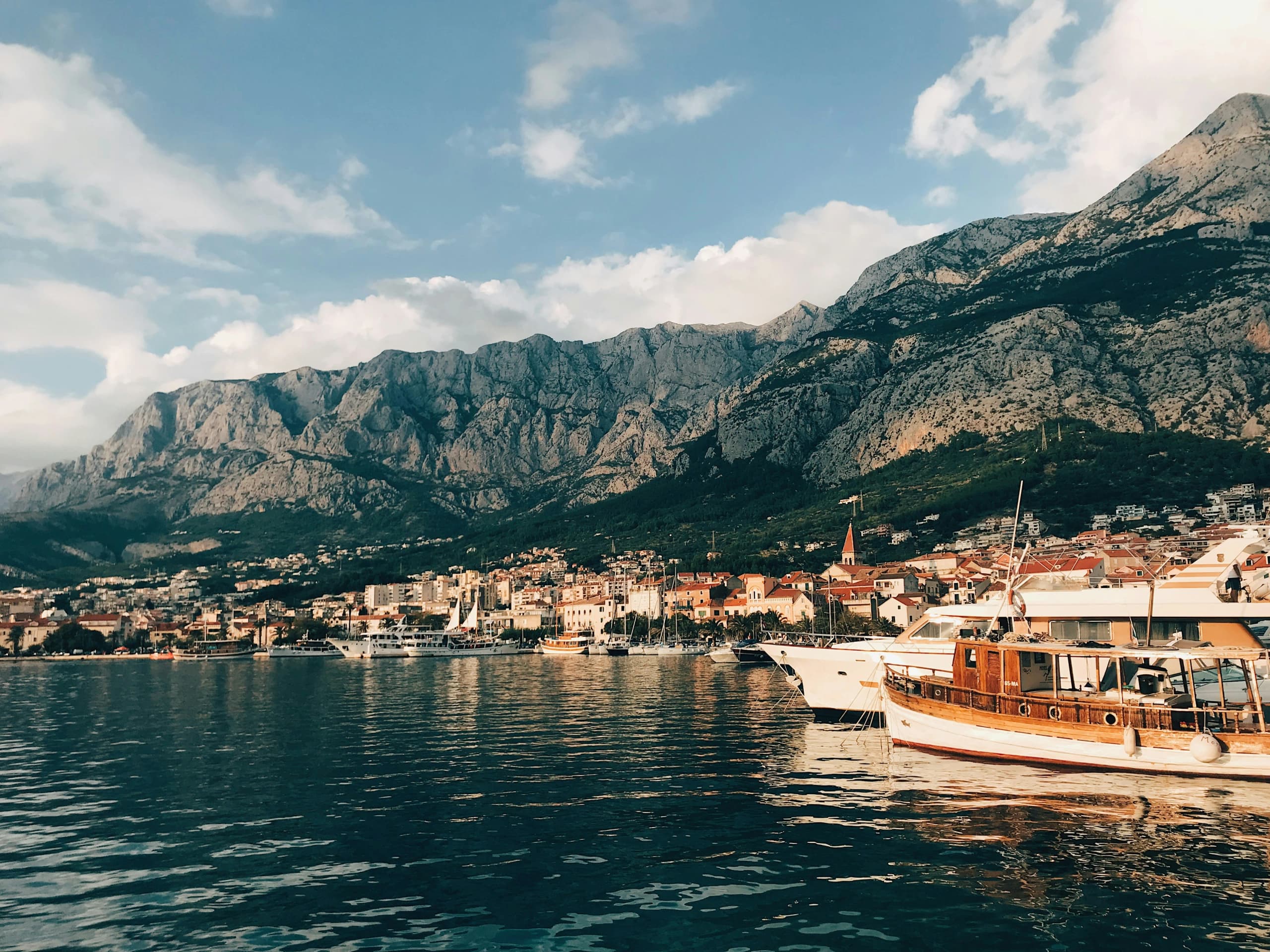 Makarska seen from the water, with the Biokovo range rising behind the town